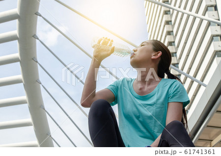 Beautiful fitness athlete asian woman drinking 61741361