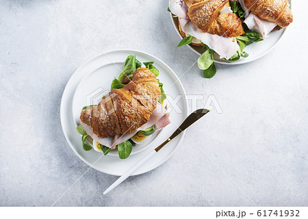 Fresh croissant with green salad 61741932