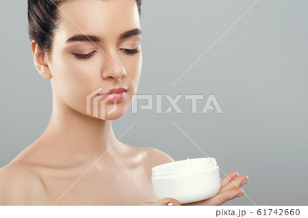 Woman Holding Cosmetic Cream. Beauty Face. 61742660