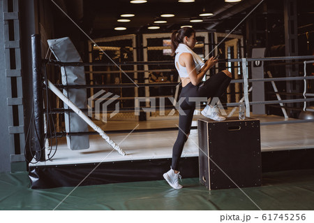 Beautiful young woman in sportswear posing on camera in the gym Beautiful young woman in sportswear posing on camera in the gym 61745256