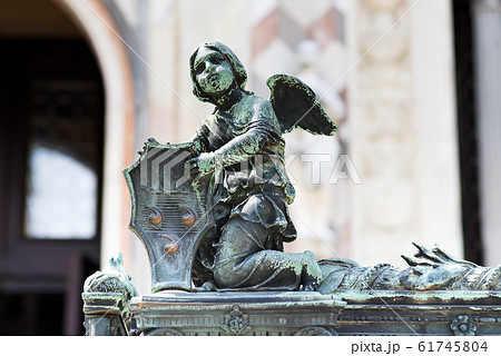 Angel holding a shield with Colleoni Coat of Arms as a decoration of the fence of Bergamo cathedral in Italy Angel holding a shield with Colleoni Coat of Arms as a decoration of the fence of Bergamo cathedral in Italy 61745804