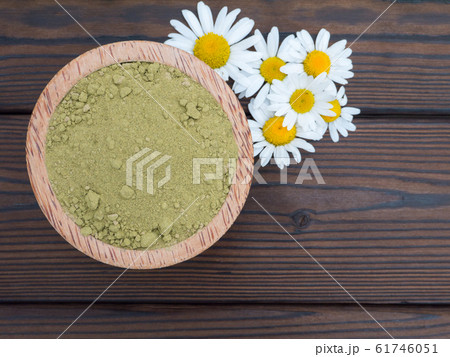 Henna powder in the coconut bowl and chamomile 61746051