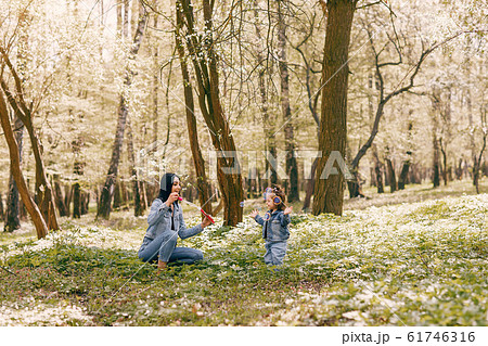 Cute and stylish family in a spring park Cute and stylish family in a spring park 61746316