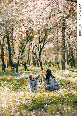 Cute and stylish family in a spring park Cute and stylish family in a spring park 61746322