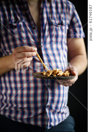 Overweight man with plate of bread sticks Overweight man with plate of bread sticks 61746587