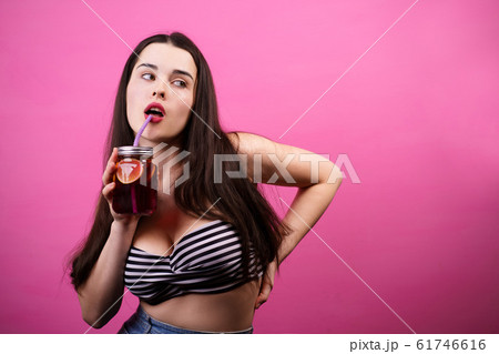 woman drinking lemonade or iced tea from jar woman drinking lemonade or iced tea from jar 61746616