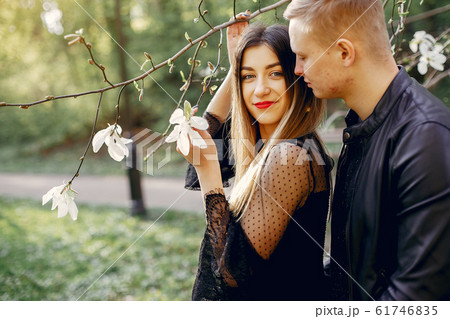 Beautiful couple spend time in a spring park 61746835