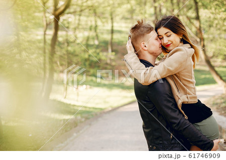 Beautiful couple spend time in a spring park Beautiful couple spend time in a spring park 61746909