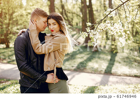 Beautiful couple spend time in a spring park Beautiful couple spend time in a spring park 61746946