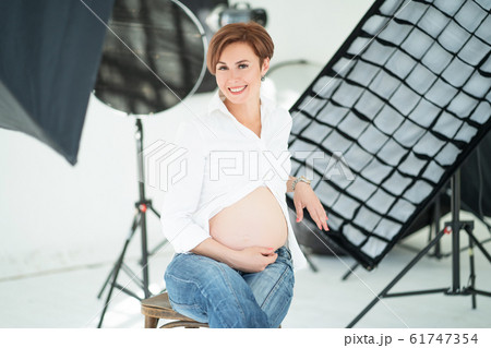 Adult Pregnant Woman's Photo Shoot Expecting Concept 61747354