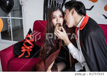 Couple in costume witch and dracula with celebrate Couple in costume witch and dracula with celebrate 61757035