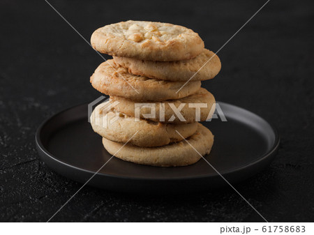 White chocolate biscuit cookies on black ceramic 61758683