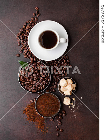 White cup of fresh raw organic coffee with beans White cup of fresh raw organic coffee with beans 61758741