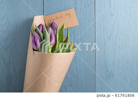 top view of purple tulips on blue wood background with valentines day card top view of purple tulips on blue wood background with valentines day card 61761806