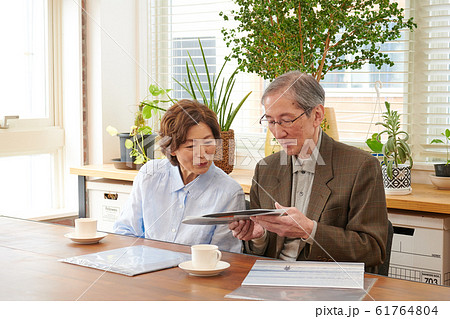 レコードを懐かしんで見るシニア夫婦 61764804