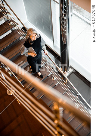 Top view of the stairs and woman walking down stock photo Top view of the stairs and woman walking down stock photo 61767649