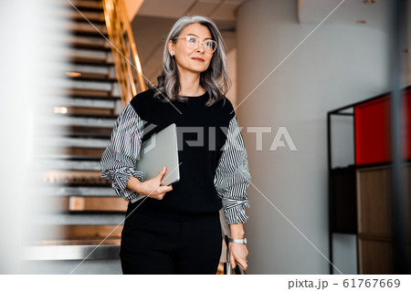 Beautiful smiling boss with modern laptop stock photo Beautiful smiling boss with modern laptop stock photo 61767669