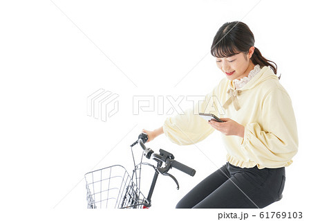 自転車でスマホを使う若い女性 61769103