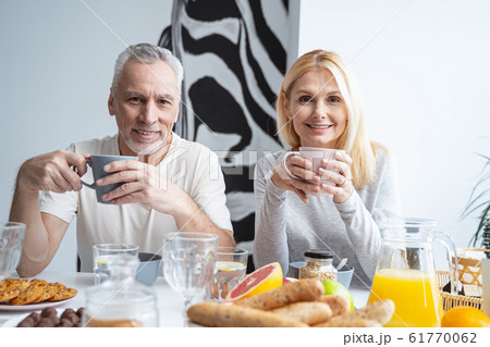 Joyful couple with delicious tea in the kitchen stock photo 61770062
