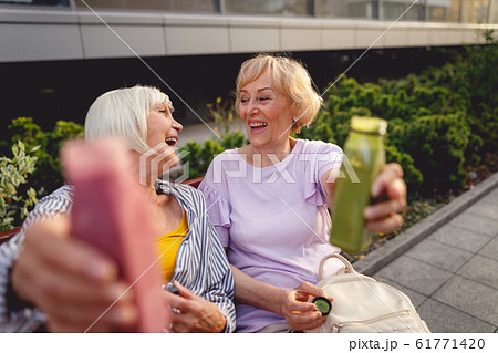 Beautiful old ladies spending their evening in the downtown 61771420