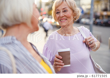 Woman telling good bye to her friend Woman telling good bye to her friend 61771505