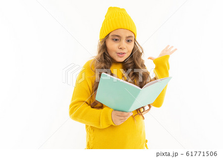 Happy caucasian girl in yellow hat and hoody read a book isolated on white background Happy caucasian girl in yellow hat and hoody read a book isolated on white background 61771506