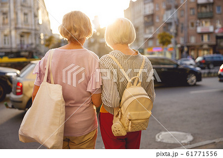 Friends looking at the cars on the road Friends looking at the cars on the road 61771556