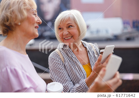 Woman sharing her impressions with a friend Woman sharing her impressions with a friend 61771642