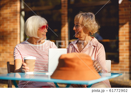 Old friends having a conversation in the cafe Old friends having a conversation in the cafe 61772902