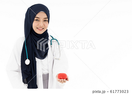 Muslim doctor hold red heart Muslim doctor hold red heart 61773023