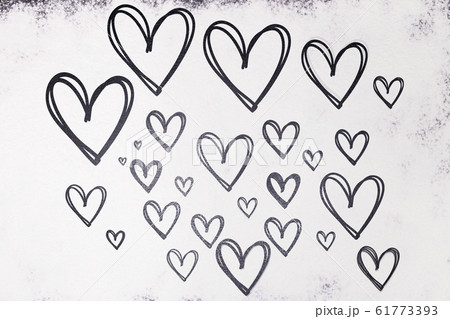 Texture of drawn hearts in black on a white background from flour. Valentine's Day. Texture of drawn hearts in black on a white background from flour. Valentine's Day. 61773393