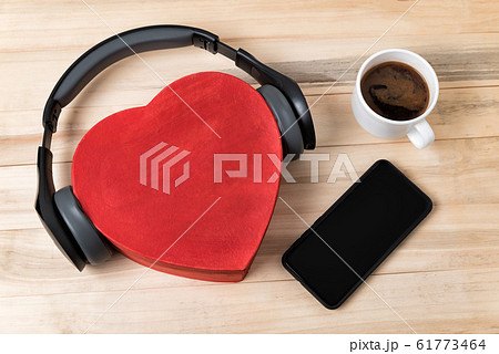 Heart box with headphones, phone and cup of coffee Heart box with headphones, phone and cup of coffee 61773464