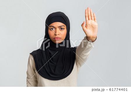 Serious Black Muslim Woman In Headscarf Showing No With Her Hand Serious Black Muslim Woman In Headscarf Showing No With Her Hand 61774401