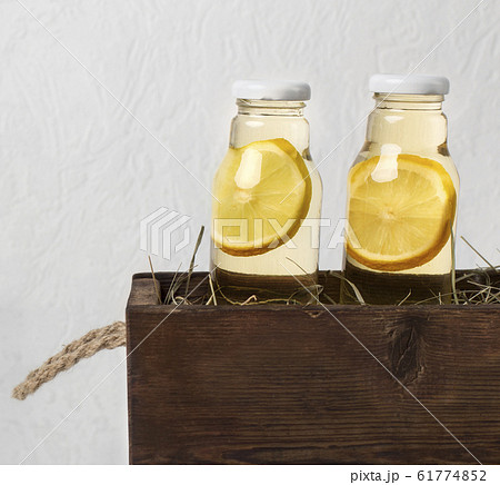 Citrus fruits and herbs infused water for detox diet in wooden box Citrus fruits and herbs infused water for detox diet in wooden box 61774852