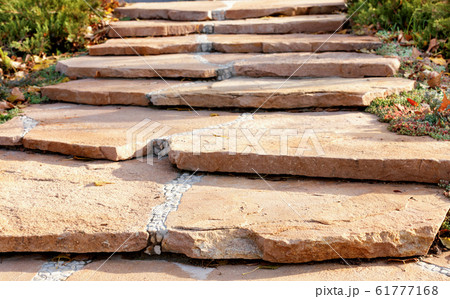 A paved path made of coarse sandstone 61777168