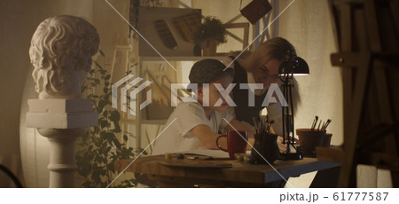 Teacher and student in art class Teacher and student in art class 61777587