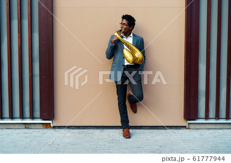 Funny handsome man with a golden color inflatable tube Funny handsome man with a golden color inflatable tube 61777944