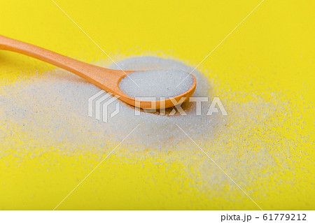 Picture of spoon and sugar isolated over the yellow background. Sugar is bad. Picture of spoon and sugar isolated over the yellow background. Sugar is bad. 61779212