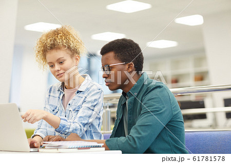 Students Using Laptop in Library 61781578