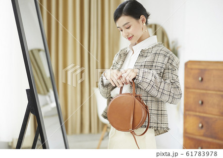 自室でドレスアップをする女性 61783978