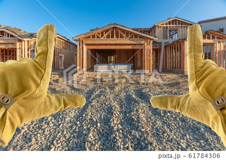 Male Contractor Hands Framing Unfinished House Male Contractor Hands Framing Unfinished House 61784306