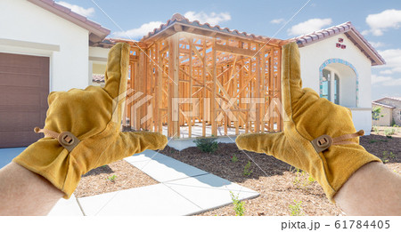 Male Contractor Hands Framing Unfinished Section of Construction Sketch Male Contractor Hands Framing Unfinished Section of Construction Sketch 61784405