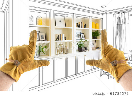 Male Contractor Hands Framing Completed Section of Sketch Blueprints Male Contractor Hands Framing Completed Section of Sketch Blueprints 61784572