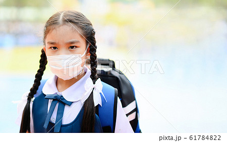 School Girl wearing mouth mask against air smog School Girl wearing mouth mask against air smog 61784822