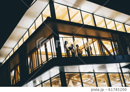 仕事の合間に話をするビジネスマンとビジネスウーマン 仕事の合間に話をするビジネスマンとビジネスウーマン 61785200