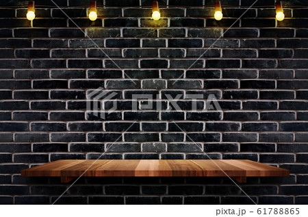 Empty brown plank wood shelf at black brick wall Empty brown plank wood shelf at black brick wall 61788865