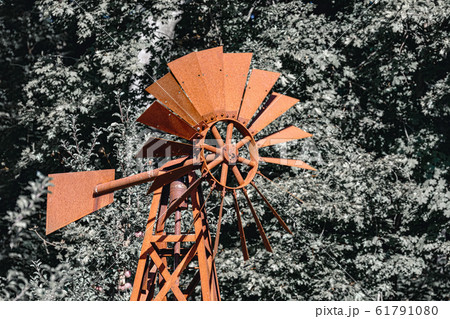 Wind powered water pump with rusty pipes Wind powered water pump with rusty pipes 61791080