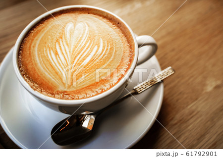 cup of the latte art coffee with warm light 61792901