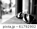 Single simple sun glasses on the wooden table with 61792902