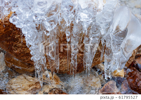 bizarre white winter icicles on river stone bizarre white winter icicles on river stone 61795527
